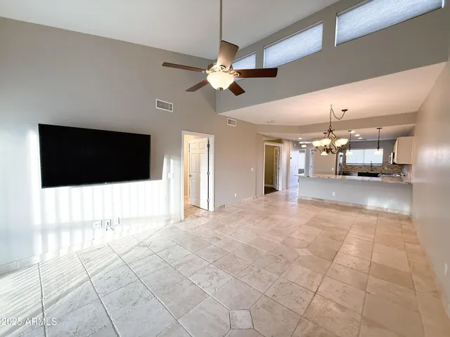a view of an empty room with a kitchen
