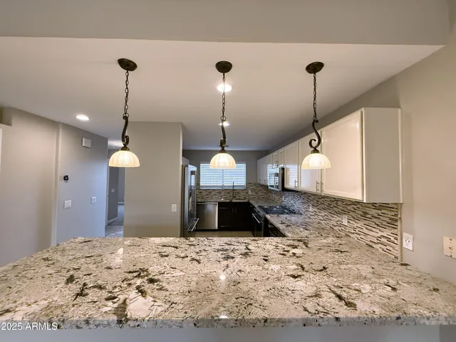 a bed room with a bed and a chandelier