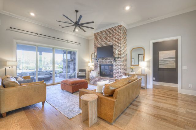 a living room with furniture flat screen tv and a fireplace