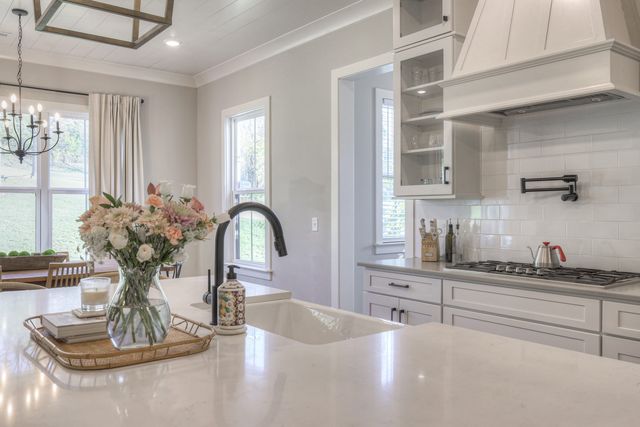 a kitchen with stainless steel appliances a dining table and chairs
