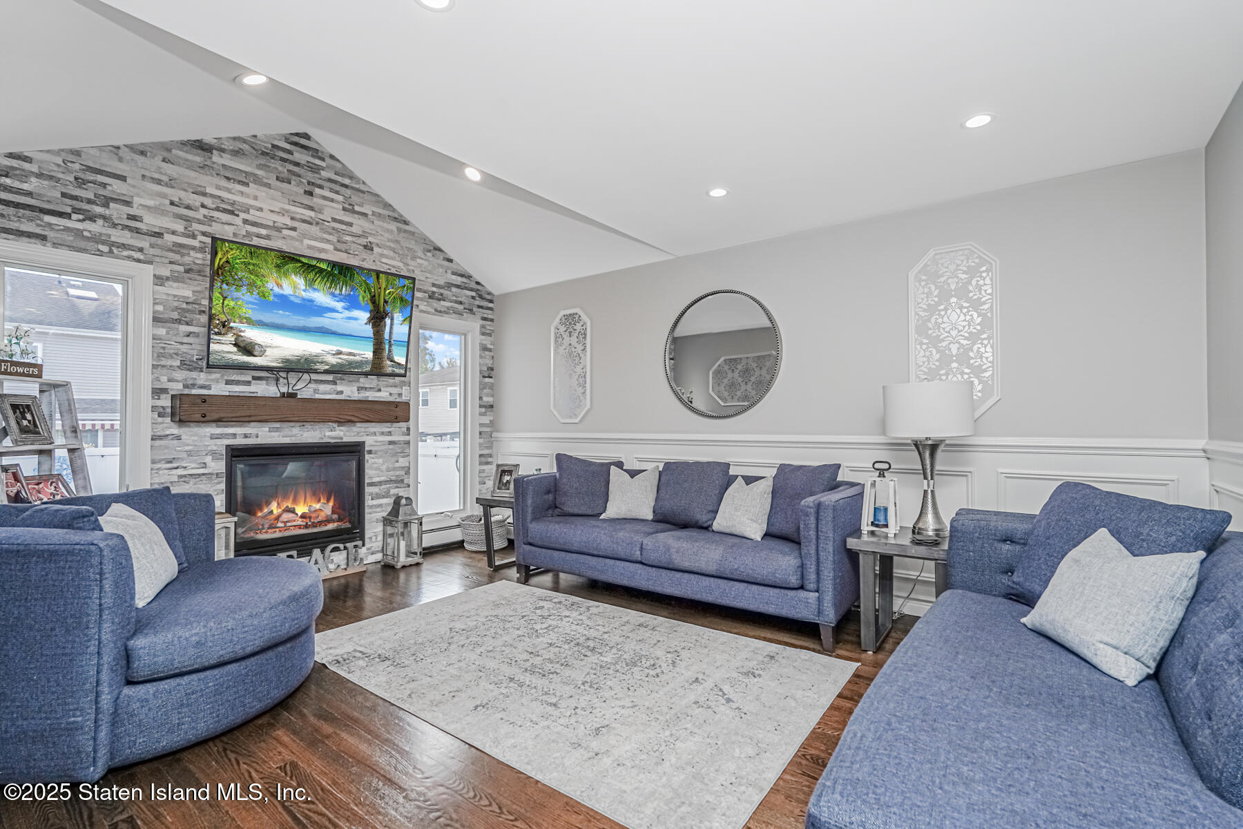 26 Rochelle Place Staten Island, NY 10312 - Photo 21 of 47 a living room with furniture a fireplace and a flat screen tv