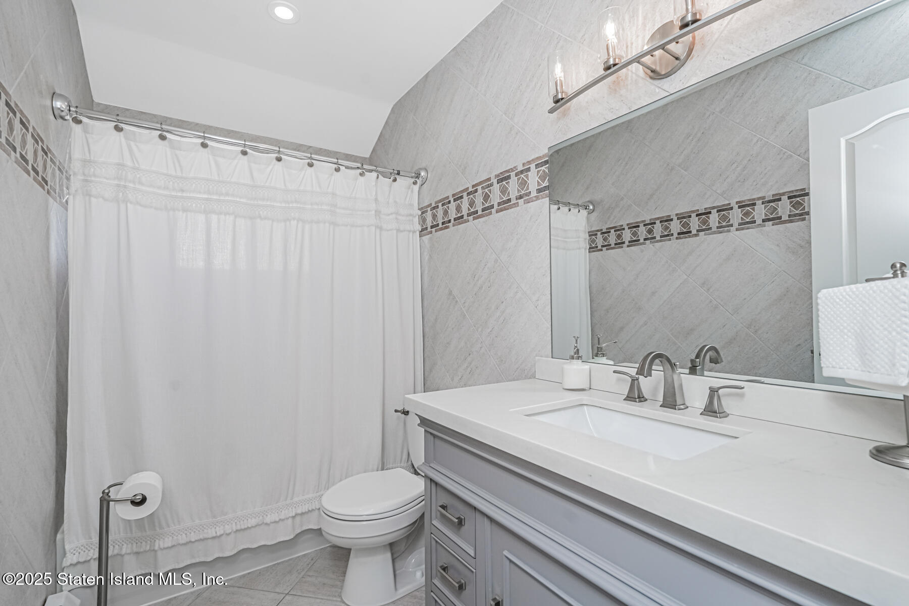 26 Rochelle Place Staten Island, NY 10312 - Photo 29 of 47 a bathroom with a sink a toilet and shower