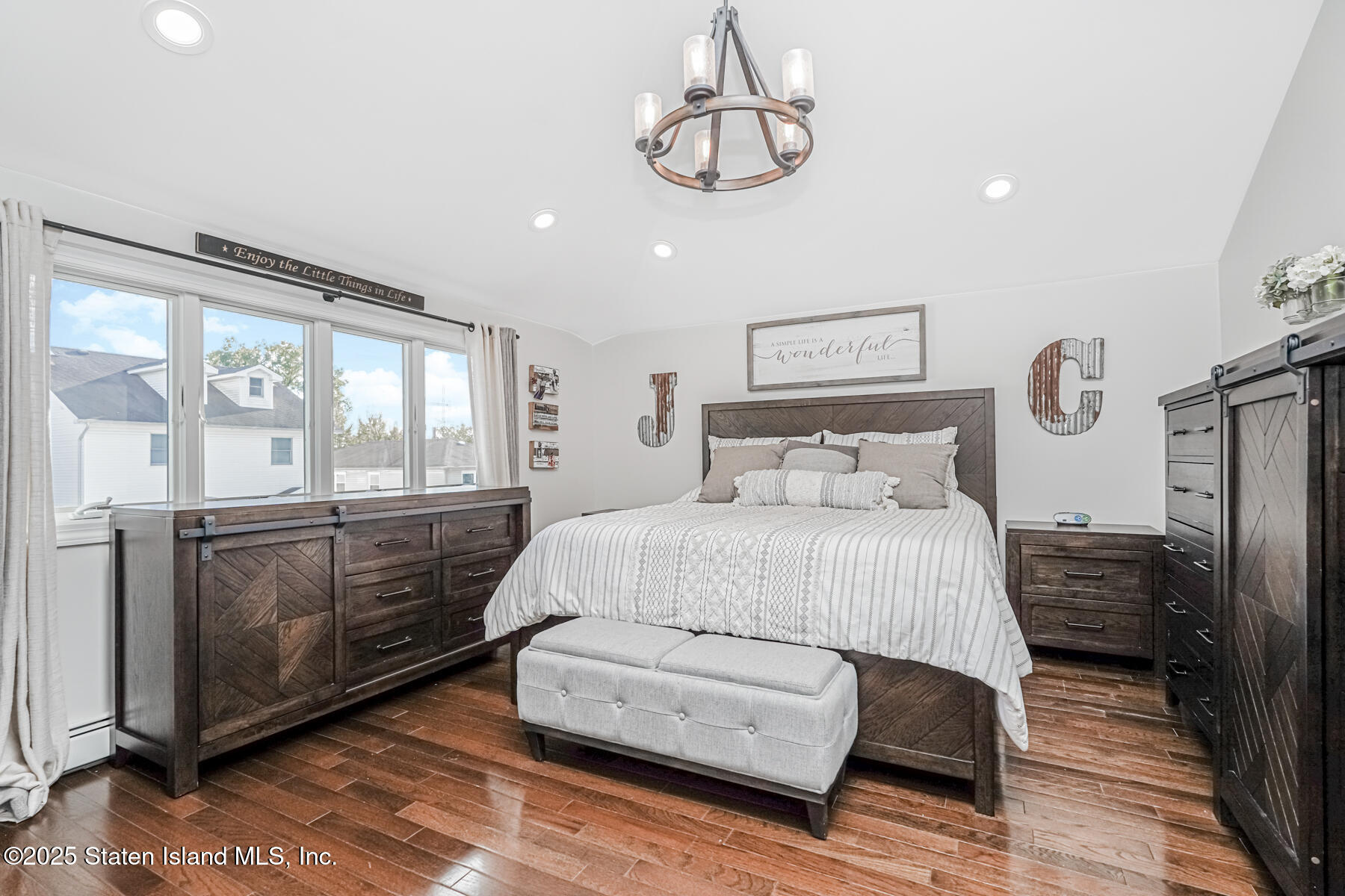 26 Rochelle Place Staten Island, NY 10312 - Photo 31 of 47 a bedroom with a bed and wooden floor