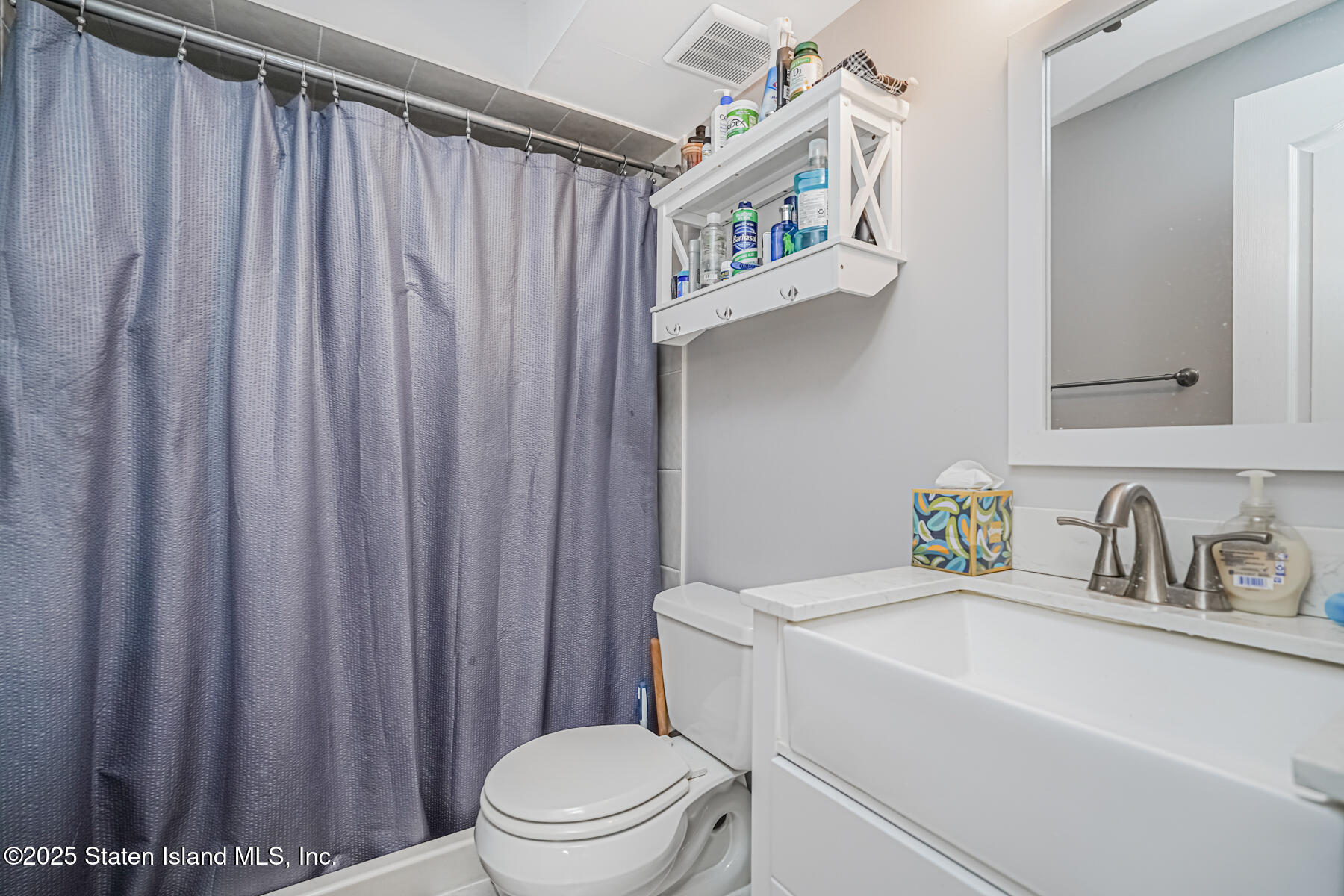 26 Rochelle Place Staten Island, NY 10312 - Photo 40 of 47 a bathroom with a sink a toilet and shower curtain