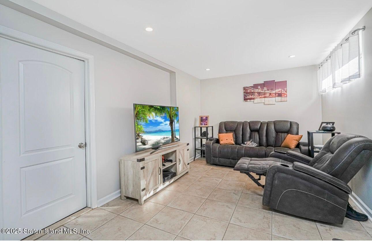 26 Rochelle Place Staten Island, NY 10312 - Photo 41 of 47 a living room with furniture and a flat screen tv