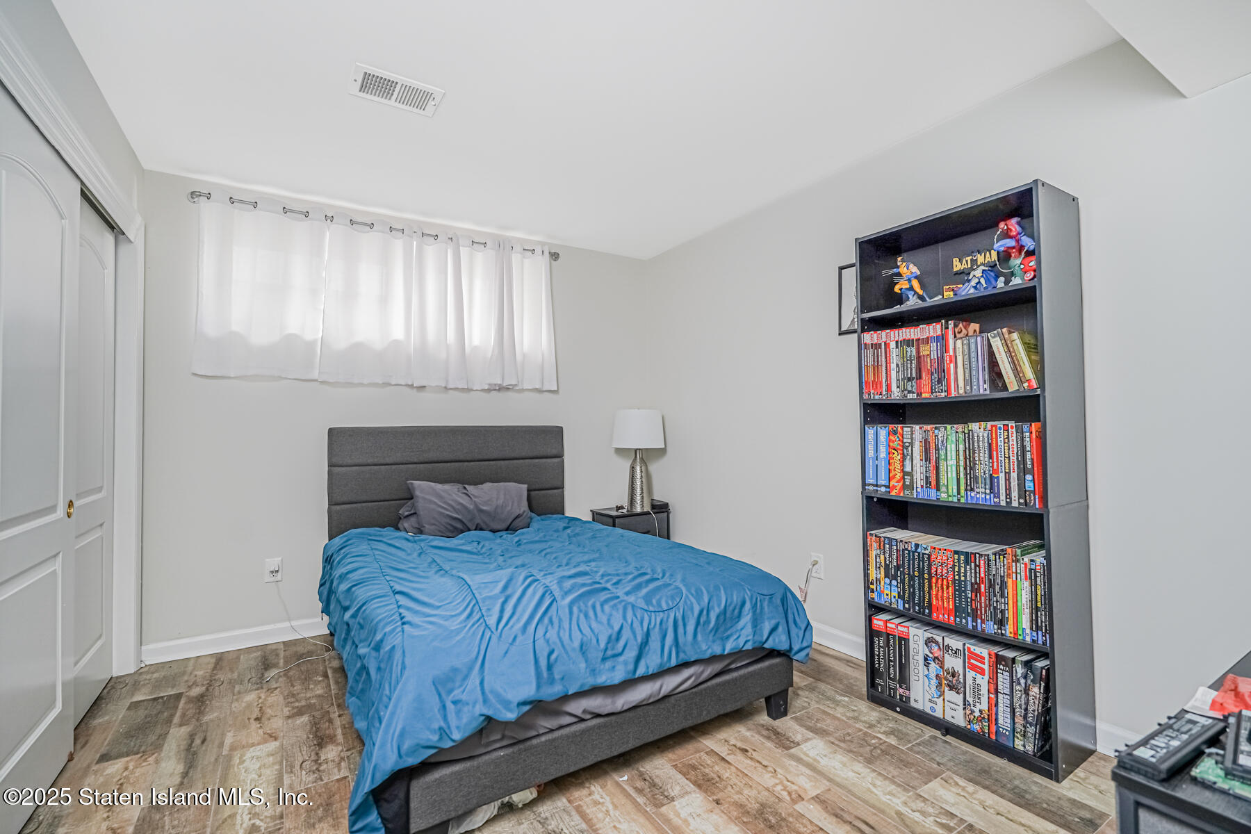 26 Rochelle Place Staten Island, NY 10312 - Photo 42 of 47 a bedroom with a bed and a book shelf