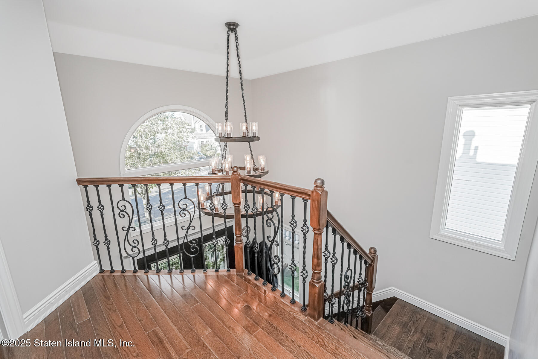 26 Rochelle Place Staten Island, NY 10312 - Photo 5 of 47 a view of staircase with railing and wooden floor