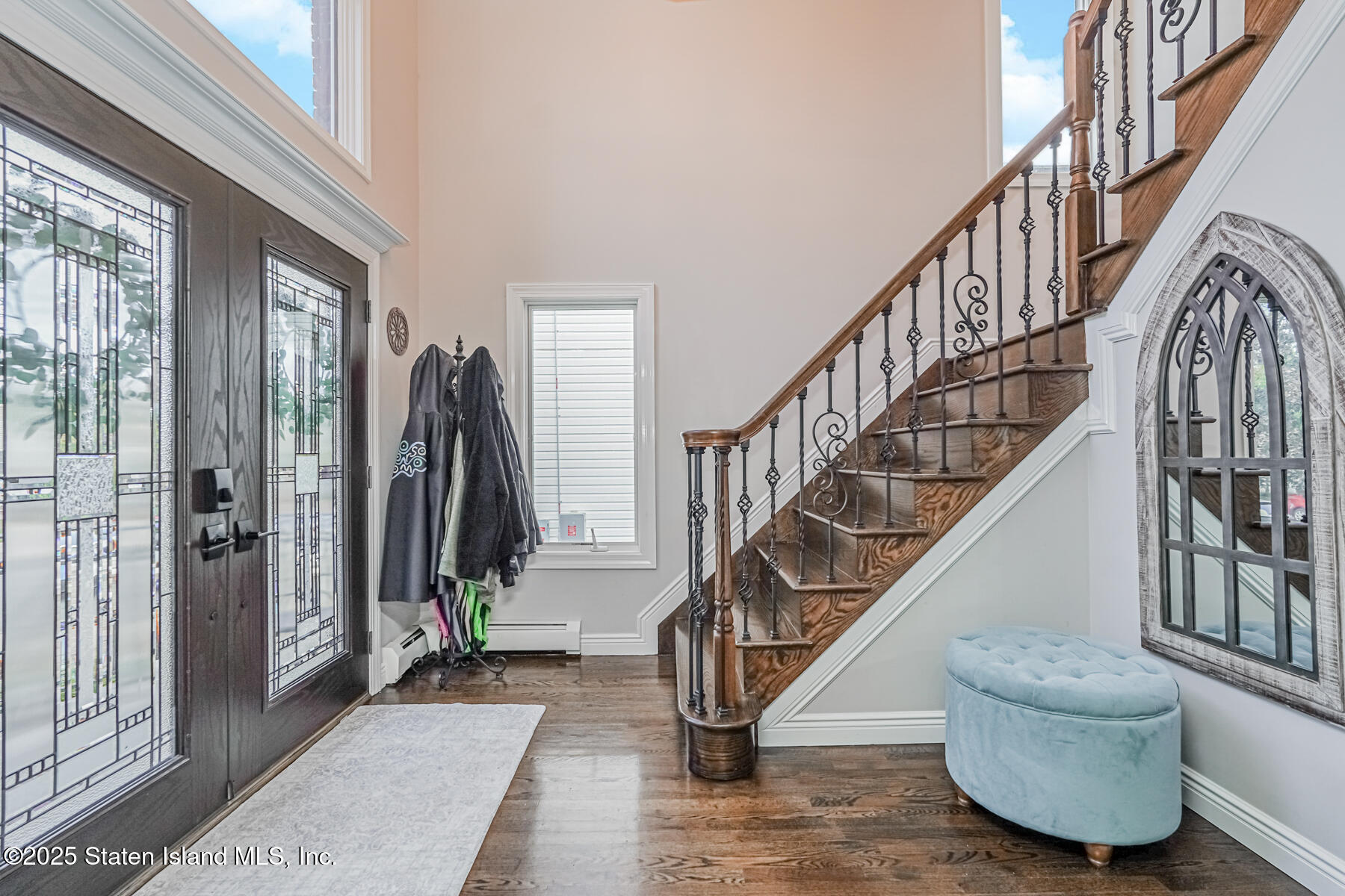 26 Rochelle Place Staten Island, NY 10312 - Photo 6 of 47 a view of staircase with lots of frames and couches