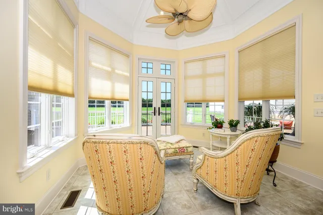 a view of a dining room with furniture a chandelier and wooden floor