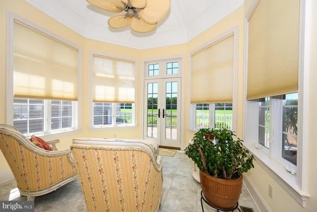 a view of a roof deck with wooden floor and fence next to a yard