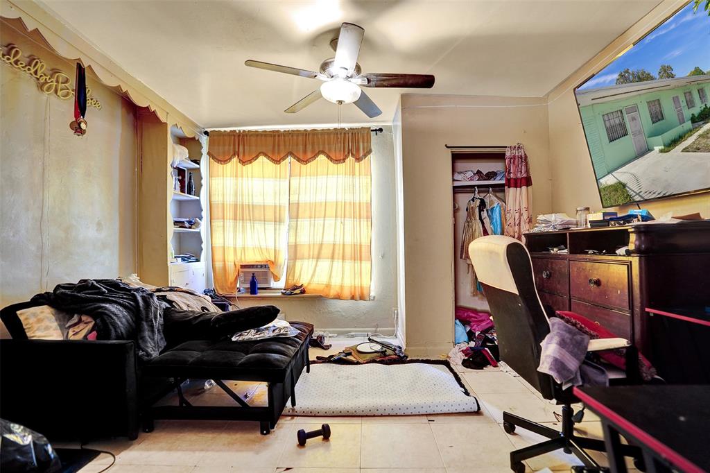 57 Northwest 68th Street Miami, FL 33150 - Photo 15 of 36 a bedroom with furniture a bed and a chandelier