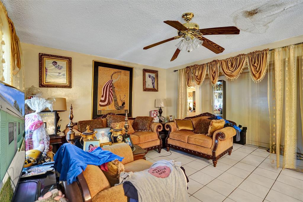 57 Northwest 68th Street Miami, FL 33150 - Photo 16 of 36 a living room with furniture ceiling fan and a window