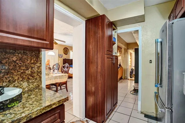 a en suite bathroom with a granite countertop sink and a mirror