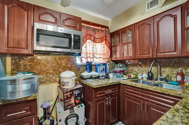 a kitchen with stainless steel appliances granite countertop a stove and a microwave