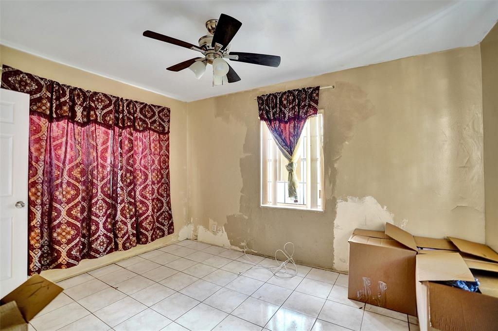 57 Northwest 68th Street Miami, FL 33150 - Photo 24 of 36 a view of a livingroom with a window and a ceiling fan