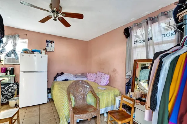 a bedroom with furniture and a book shelf