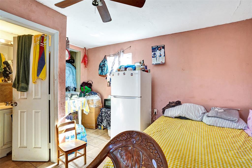 57 Northwest 68th Street Miami, FL 33150 - Photo 28 of 36 a bedroom with a bed and a dresser