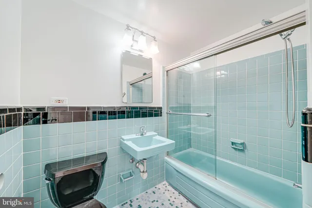 a bathroom with a sink a toilet and bathtub