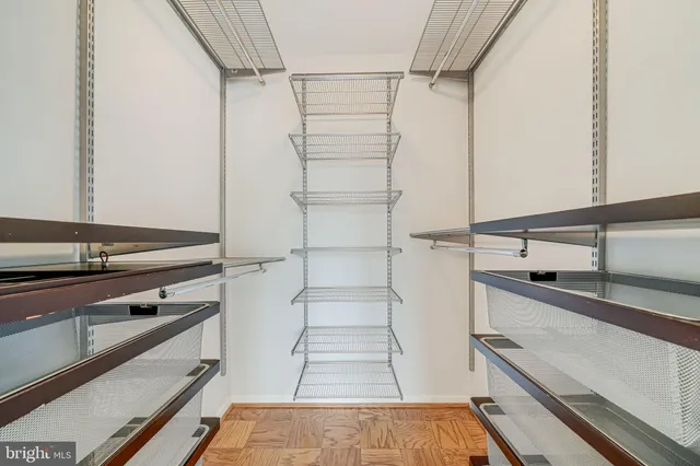 a view of walk in closet with empty racks