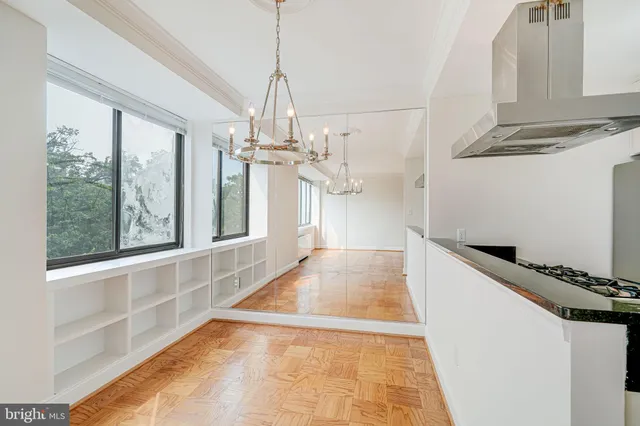 a view of a kitchen with a sink and windows