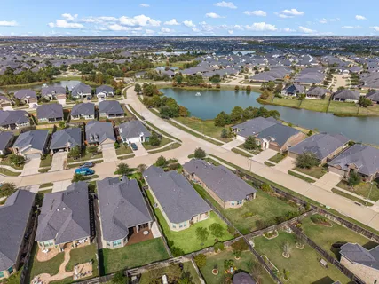 an aerial view of residential houses with outdoor space