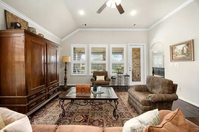 a living room with furniture windows and wooden floor