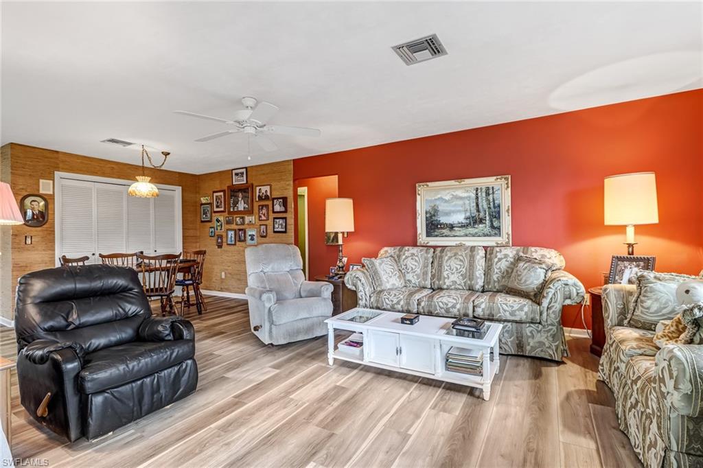355 Valley Stream Circle Naples, FL 34113 - Photo 13 of 31 a living room with furniture and a large window