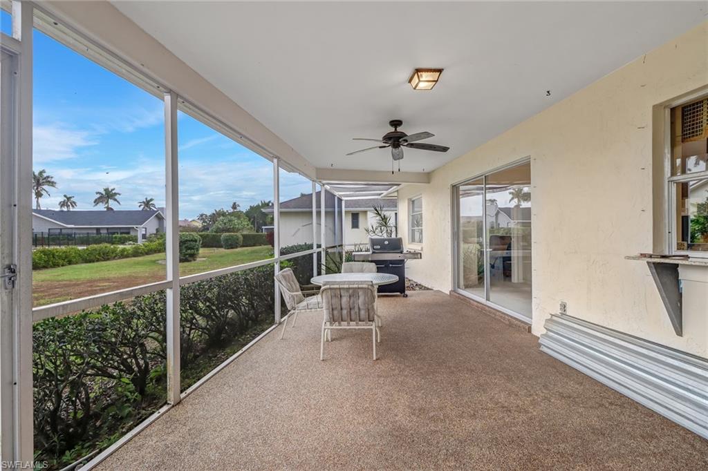 355 Valley Stream Circle Naples, FL 34113 - Photo 22 of 31 a view of a porch with chairs and backyard