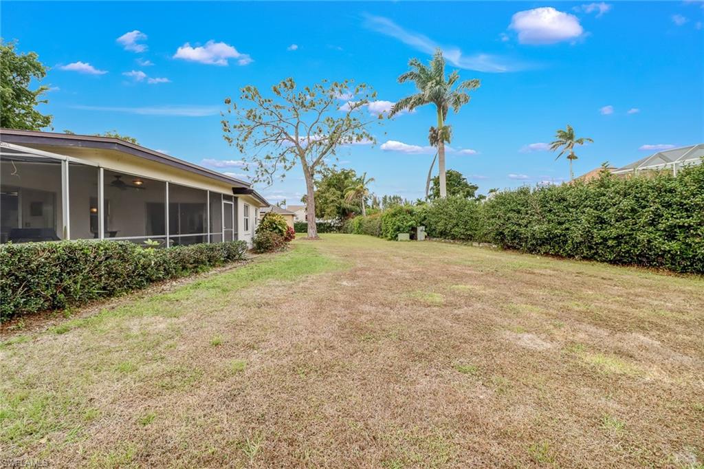 355 Valley Stream Circle Naples, FL 34113 - Photo 24 of 31 a front view of a house with a yard