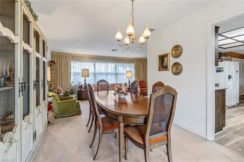 355 Valley Stream Circle Naples, FL 34113 - Photo 5 of 31 a view of a dining room with furniture and chandelier