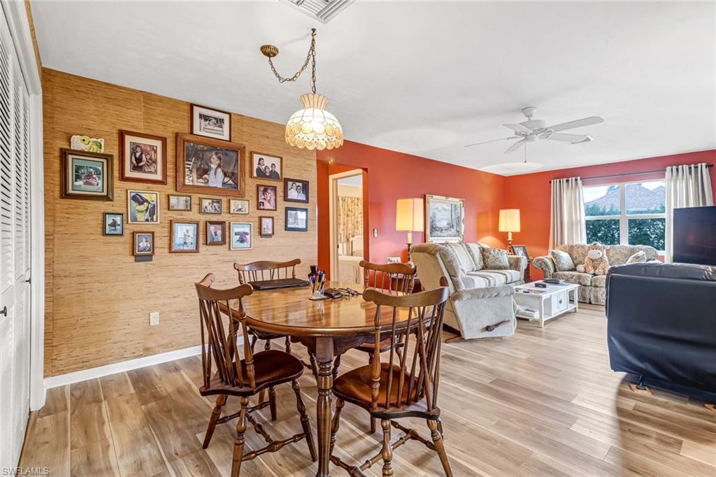 355 Valley Stream Circle Naples, FL 34113 - Photo 10 of 31 a view of a dining room with furniture wooden floor and chandelier
