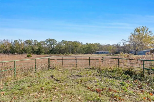 a view of outdoor space with green field and trees