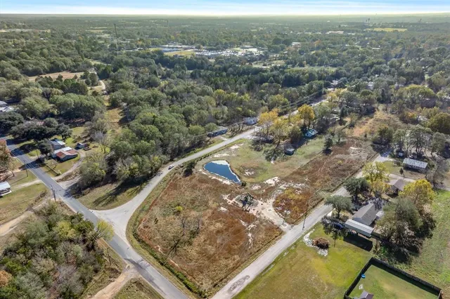 an aerial view of a residential houses with outdoor space
