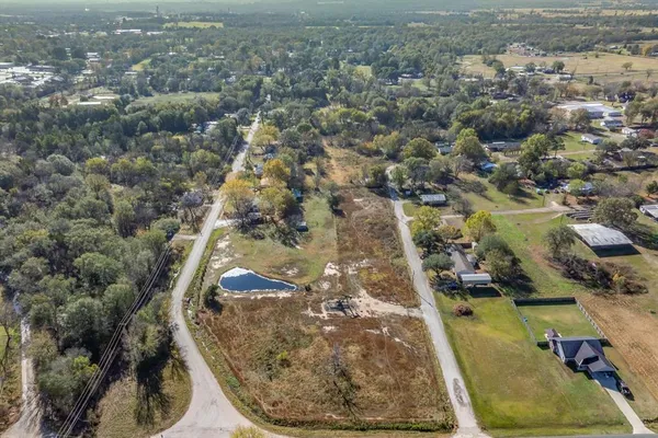 an aerial view of a residential houses with outdoor space