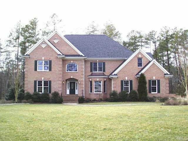 7120 Trenton Ridge Court Raleigh, NC 27613 - Photo 1 of 1 a front view of a house with a garden
