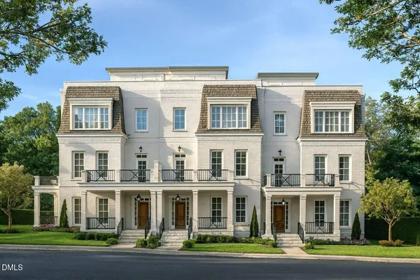 a front view of a residential apartment building with a yard