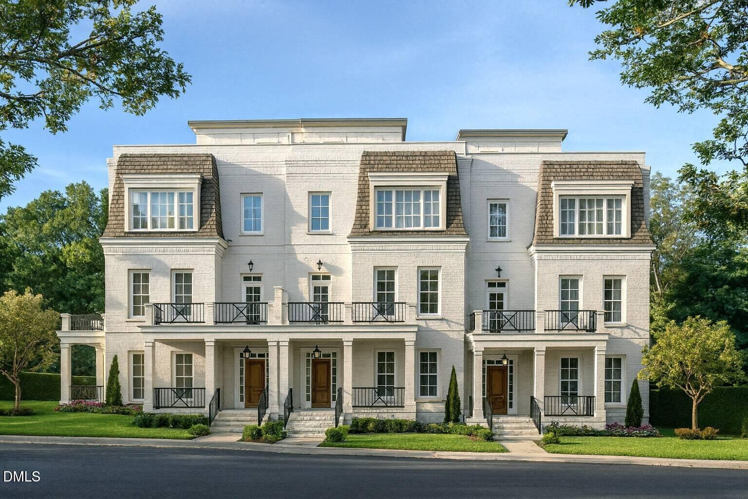 a front view of a residential apartment building with a yard