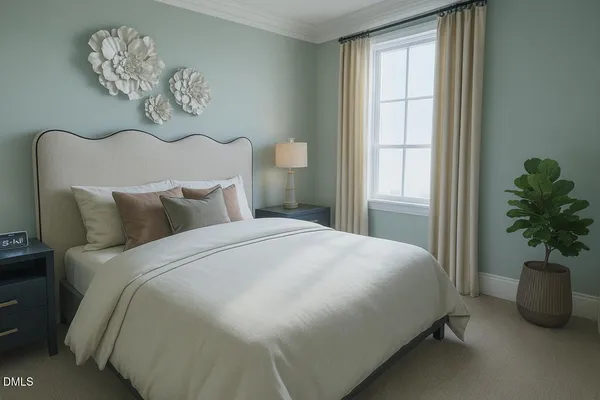 a bedroom with a bed and a potted plant