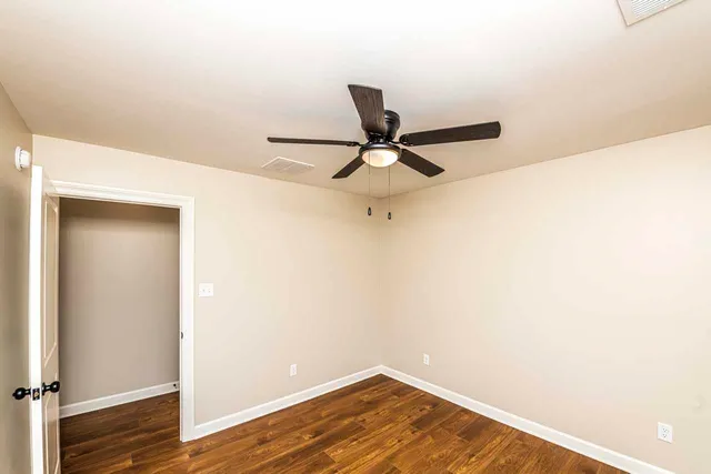 a view of a room with wooden floor