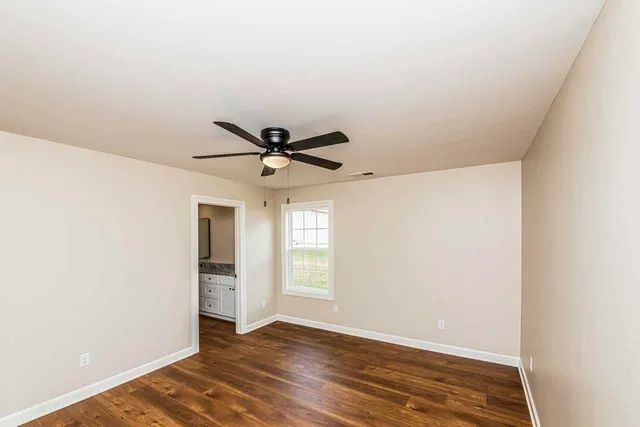 a view of a big room with wooden floor closet and windows