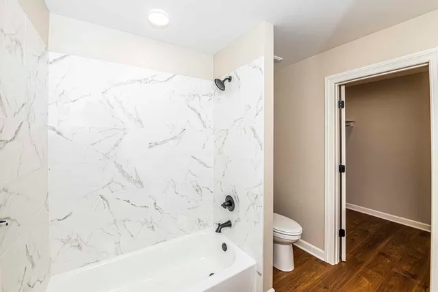 a bathroom with a bathtub and a toilet