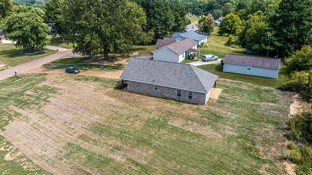 a view of a house with yard and a tree