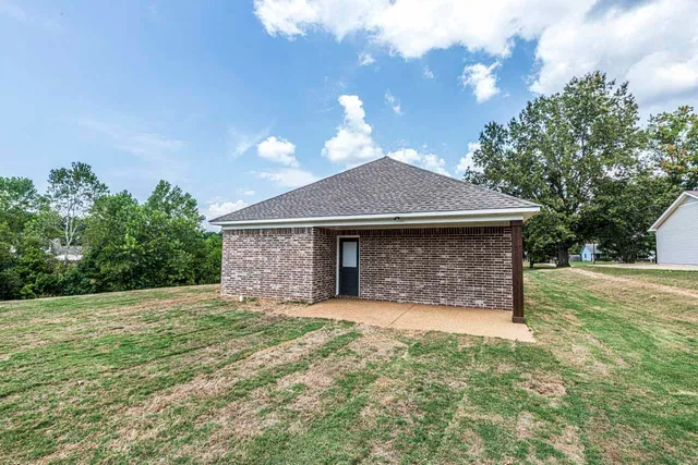 a front view of a house with yard and garage