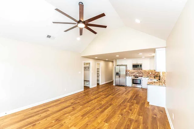 a view of a kitchen with a sink and a refrigerator