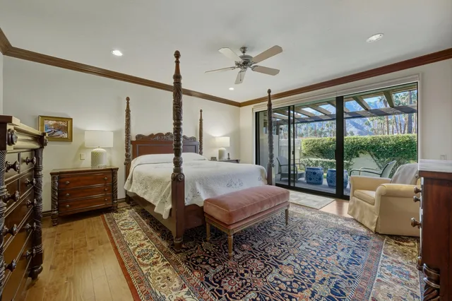 a bedroom with a bed a couch and a large window