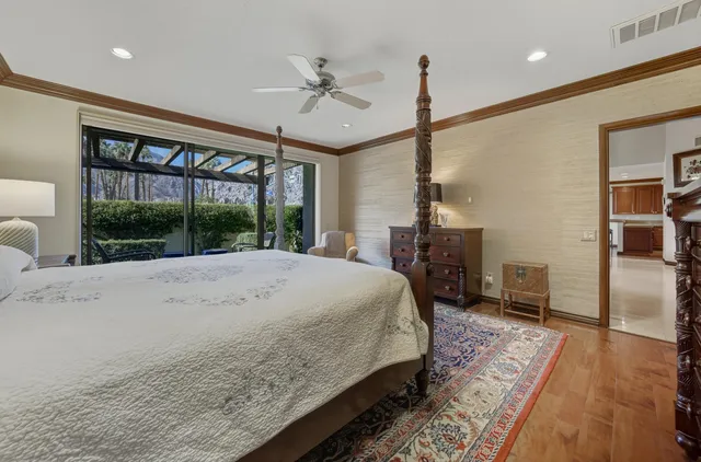 a bed sitting in a spacious bedroom next to a window