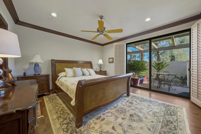 a bedroom with a bed mirror and window