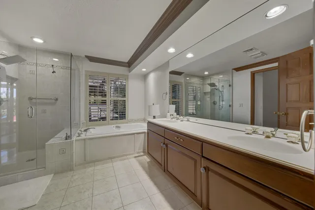 a bathroom with a granite countertop sink mirror and bathtub