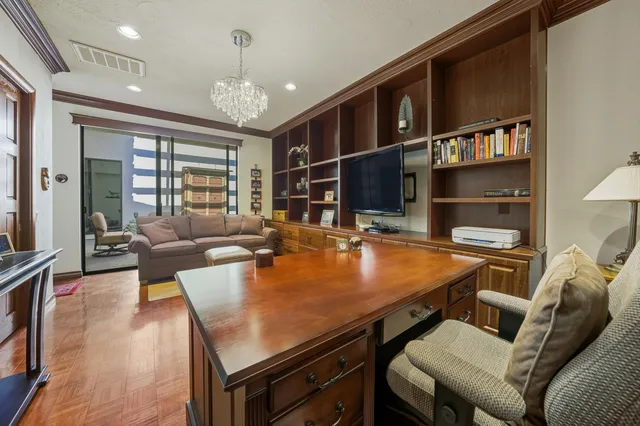 a dining room with furniture and chandelier