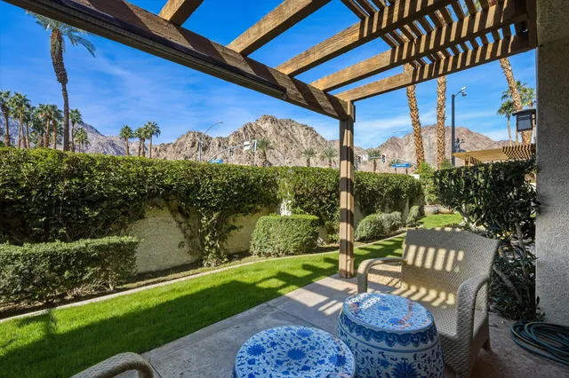 a view of a patio with couches table and chairs and potted plants